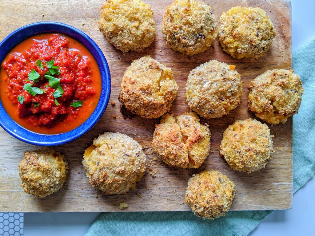 baked arancini with red pepper dip
